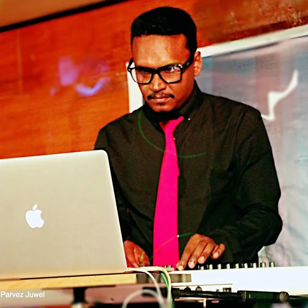 Parvez Juwel at his keyboard and laptop